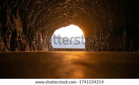 beautiful sunset in a rocky tunnel Royalty-Free Stock Photo #1741534214