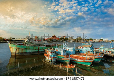 A group of fishing boats and incredible sky in the evening in Thailand