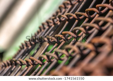 Rusty steel wire mesh fence,soft focus, Close up of metal fencing blur background, Staring down the pitcher's mound through the fence