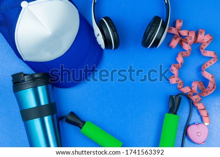 Fitness equipment accessories over blue backgound.Workout objects with top view and copy space.