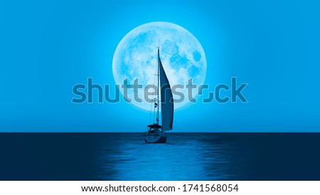 Lone yacht with super blue full moon "Elements of this image furnished by NASA "
