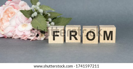 from text made of wooden cube on White background.