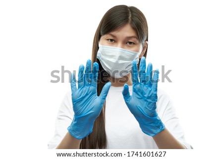 Young asian girl in medical mask and blue gloves show give up sign on white background isolated