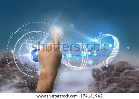Hand pointing against rocky landscape, elements of this image furnished by NASA