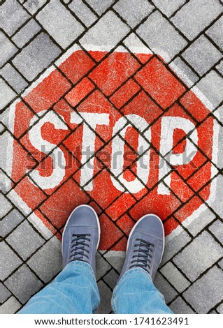 STOP sign on concrete pavement, portrait format