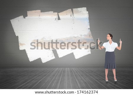 Content gorgeous businesswoman posing against display on wall showing bright sky