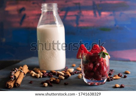 Strawberry smoothie with milk on blue background