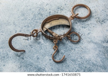 Antique brass iron rusty hand scales with hooks  on concrete background. Copy space for text.