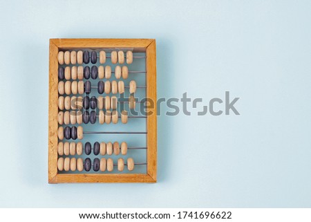 Education, training and account concept. Old wooden abacus on pure blue background.Copy space for text Royalty-Free Stock Photo #1741696622