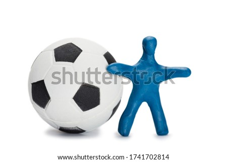 Plasticine small blue person soccer player with a ball isolated on white