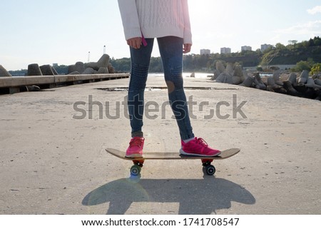 teenage girl on a skateboard on a sunny day close-up