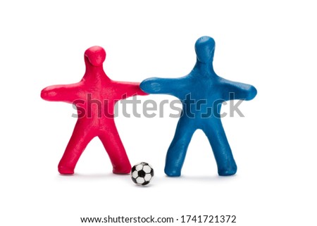 Plasticine small persons soccer red and blue players with ball isolated on white