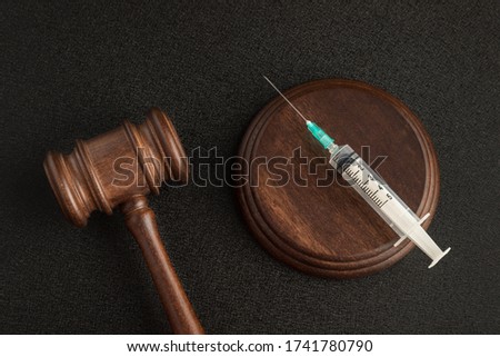 Judges gavel and syringe. Laws about medicine. Medical insurance and law concept. Royalty-Free Stock Photo #1741780790