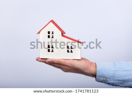 Model of house on palm on white background. Buy own house concept.