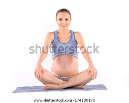 Beautiful pregnant woman making yoga
