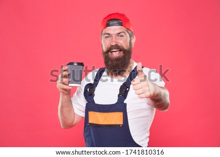 Builder enjoy coffee. Handsome builder hold coffee cup. Man protective uniform. Coffee helps enhance productivity levels, increases focus, and lowers stress levels at work. Let Me Get My Coffee.