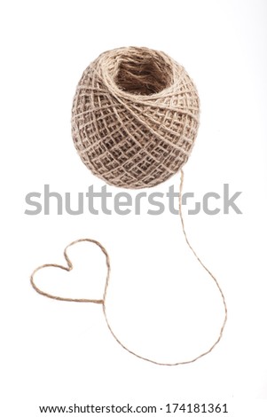 Picture of a heart made of rope, near a rope ball