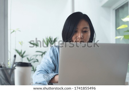 Confident asian business woman, entrepreneur female working on laptop computer at home office. Smart businesswoman searching internet, looking business solution during work process, telework concept