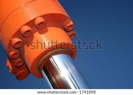 A close up of a hydraulic ram against a blue sky. Royalty-Free Stock Photo #1741898