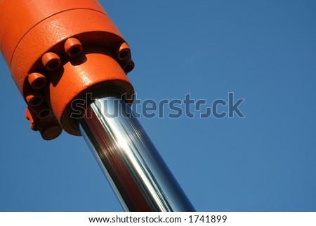 A close up of a hydraulic ram with lots of room for copy in a blue sky. Royalty-Free Stock Photo #1741899
