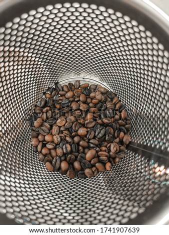 Roasting coffee beans by hand By stainless steel pot.