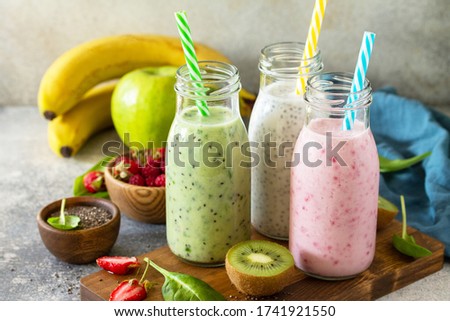 The concept of a healthy diet. Detox smoothies mix. Green smoothies vegetable and fruit smoothies on a stone concrete worktop.