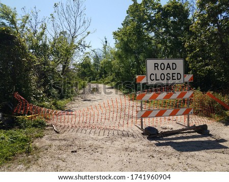 road closed sign and barricade and trail