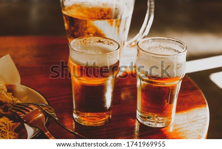 bright and light picture of two glasses of beer in the pub  