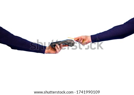 Hand holding credit card and terinal in the process of payment