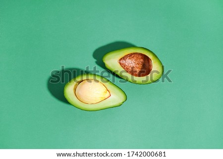 Sliced avocado on a light-green background. Flat lay. Top view. Bright picture