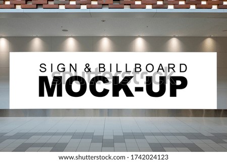 Mock up large blank horizontal billboard with clipping path on the wall of airport terminal hallway,  Empty space for media advertising design or product display