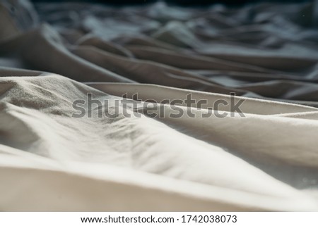 Bed after sleeping in the morning in the sun, white bed with mattress using for background.
