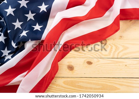 US American flag on wooden background. For USA Memorial day, Presidents day, Veterans day, Labor day, Independence or 4th of July celebration. Top view, copy space for text.