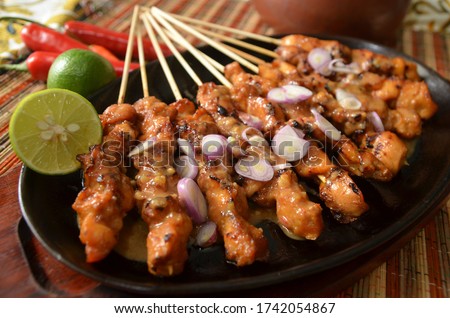 Indonesian famous street food chicken satay served with hot peanut sauce Royalty-Free Stock Photo #1742054867