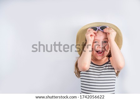 Summer vacation and holiday concept. Cute little smiling girl in a summer hat with sunglasses. Background for vacation banner, mockup