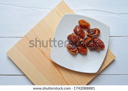 Sweet dates on white plate                 