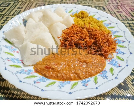 A picture of "kuah kacang" or peanut sauce with "nasi impit" or pressed rice. Traditional Malay Nusantara dish usually serve during Eid or snack time.