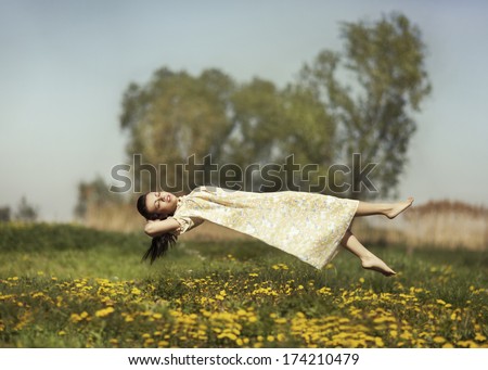 Girl in pajamas night flying over the field and dreams. Royalty-Free Stock Photo #174210479