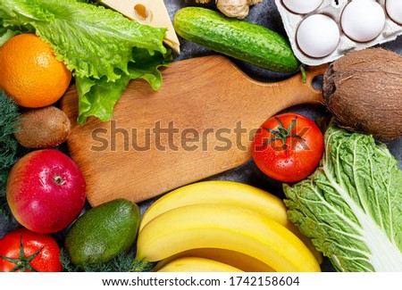 Conceptual image of a balance of healthy food with vegetables and fruits. Nutrition and diet picture with copyspace