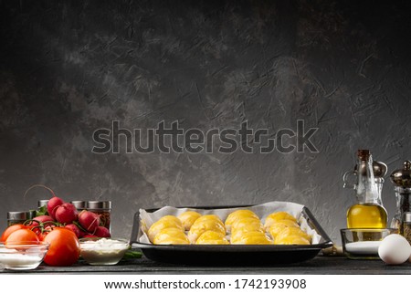 Buns on the background with ingredients, vegetables. Background for a bakery, restaurant. background on a gray wall space for writing