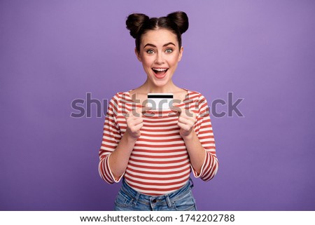 Photo of funny cheerful lady hold hands plastic credit card online purchase payment advising cool service wear white red casual striped shirt isolated purple pastel color background