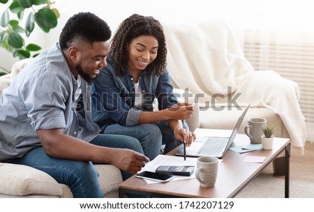 Household Budget. Smiling Black Couple Discussing Total Amount Of Their Spends At Home, Happy About Wise Planning Royalty-Free Stock Photo #1742207129