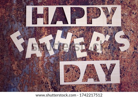 Paper cut out letters, Happy Father's Day congratulation on a dark grunge background