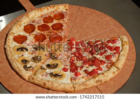 Slices of fresh pizza on a special wooden tray.