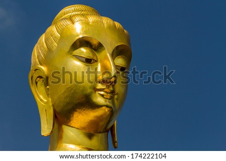Buddha portrait isolated on blue sky in thailand. 