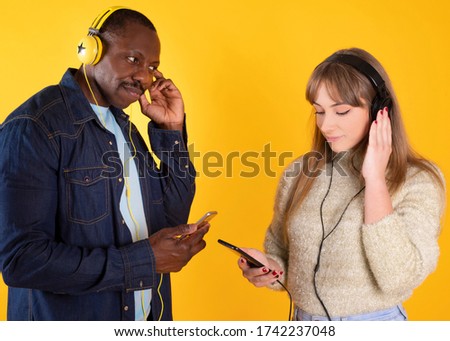 couple listening to music with headphones and mobile phone