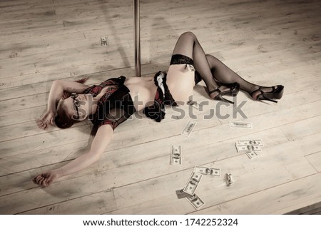 Crime scene (imitation). Pretty stripper dancer lying near the pole. 