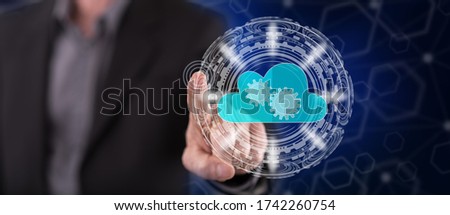 Man touching a cloud technology concept on a touch screen with his finger