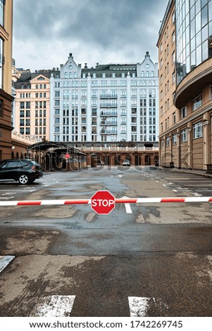 Barrier with a stop sign. New modern buildings. Kyiv, Ukraine.