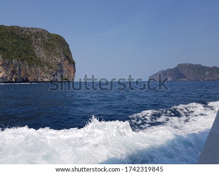 Rock mountains with boats and blue sea at phi-phi island